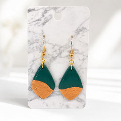 Tea-Shirt Shoppe Palm & Petal collection teardrop earrings in deep green with textured metallic gold leaf accents.